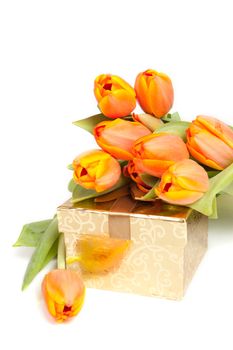 yellow orange tulips laying on a golden present