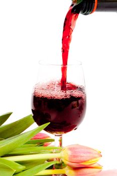 Red wine pouring into wine glass 