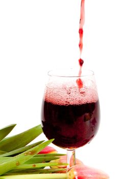 Red wine pouring into wine glass 