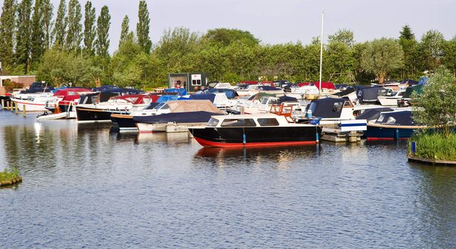 Yachts in small marina on a beautiful sunny morning 