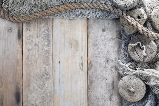 Cork, fishing net and rope with wooden background