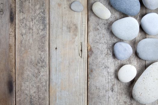 Stones with shadow on wooden background 