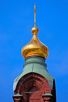 Golden dome of the Orthodox church with dark blue sky