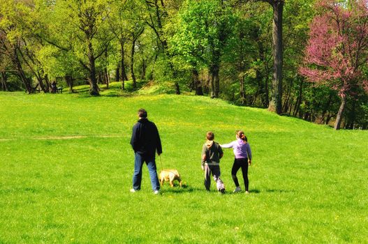 Happy family with dog in blossom park