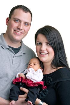 A young happy and healthy family isolated over white holding their newborn baby girl.