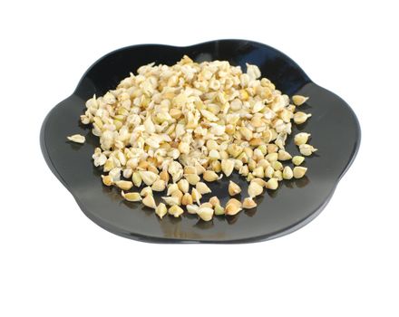 healthy nutrition rostocks of  buckwheat on plate on white