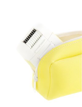 electric device epilator in yellow case on white isolated