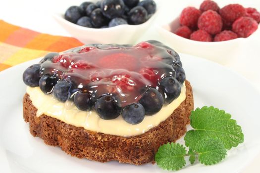 a forest fruit tarts on a cake server