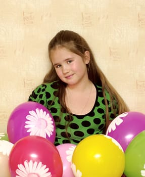 smiling girl is setting balloons