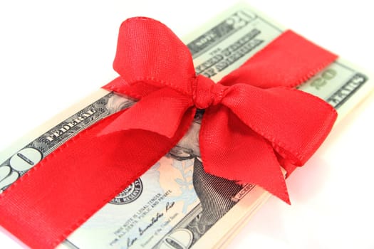 many dollar bills with a red ribbon on white background