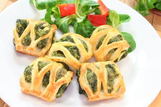 Puff pastry with spinach and cheese filling on a white plate