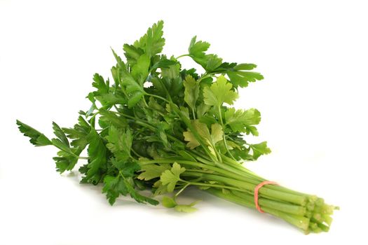 a bunch of fresh parsley on a white background