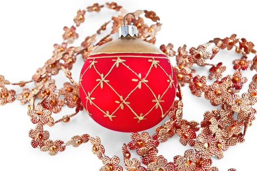 Christmas red ball with golden ornaments, shiny Christmas tree pendants in the shape of flowers isolated on white background