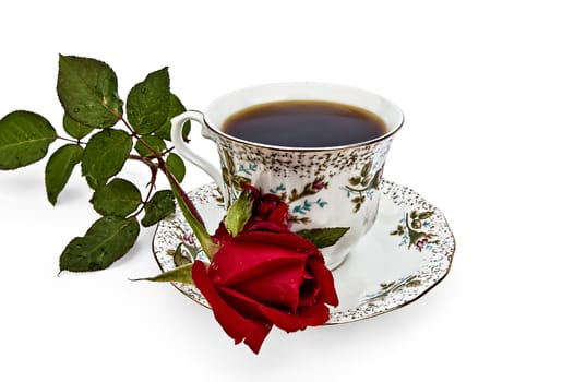 Coffee in a cup with a pattern of roses and flower red rose isolated on white background