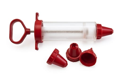 Confectionery syringe with replaceable nozzles isolated on a white background