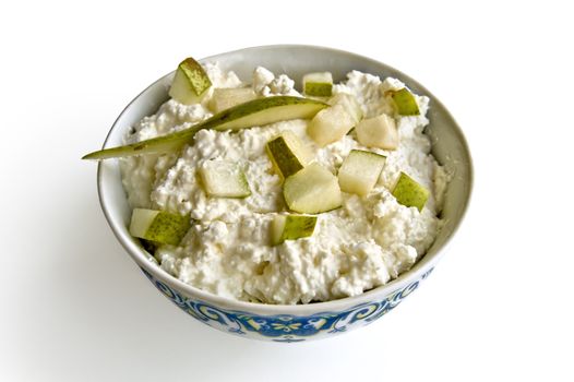 White curd with slices and a lobule of green pears in cup isolated on white background