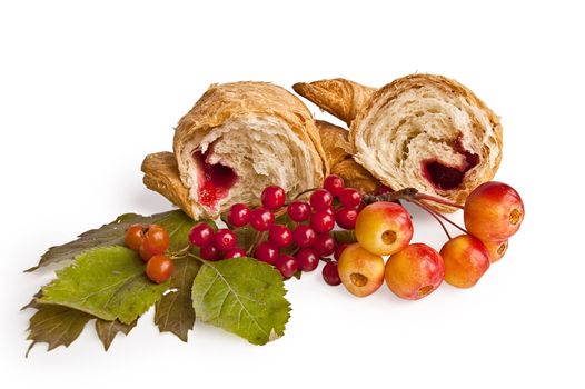 Two halves of croissants with red jam, viburnum berries and hawthorn, wild apples, green leaves isolated on white background