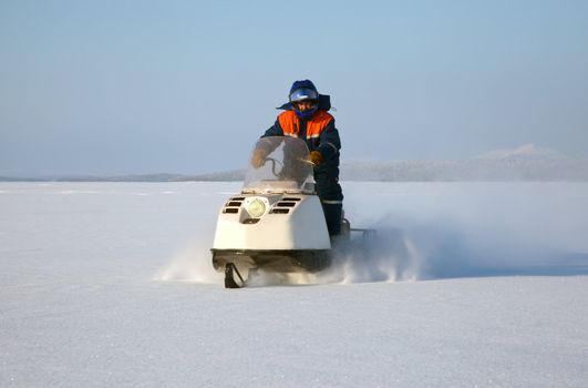 Snowmobile at full speed. Winter landscape.