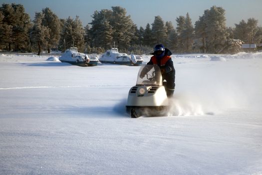 
Snowmobile at full speed. Winter landscape.
