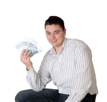 Happy young man holding a money in the form of a fan on a white background