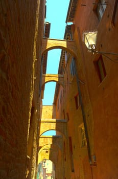 Narrow Alley With Old Buildings In Italian City of Siena