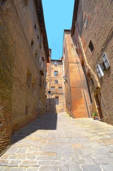 Narrow Alley With Old Buildings In Italian City of Siena