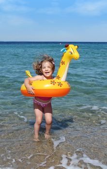 happy little girl jumps in the sea