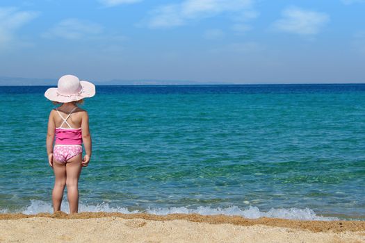 little girl looking at sea