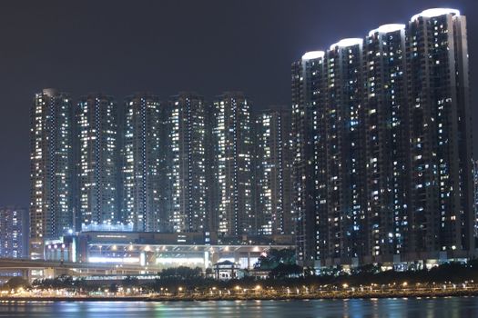 Hong Kong apartment blocks at night, showing the packed condition in this city.