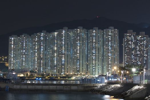 Hong Kong apartment blocks at night, showing the packed condition in this city.