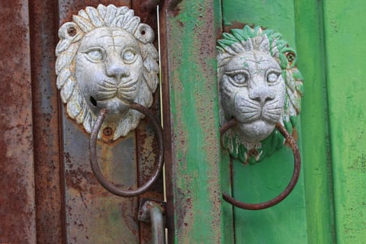 Antique lion head door knob rusted in Korean village.