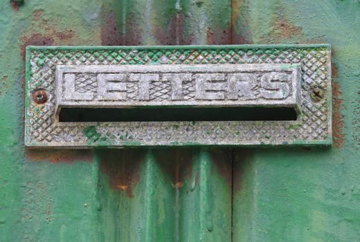 Old mailbox with letters engrave in a rusty green painted doorcan be found in korea.