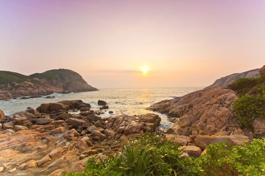 Sea rocks along the coast under sunrise