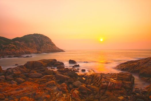 Sea stones along the coast at sunrise