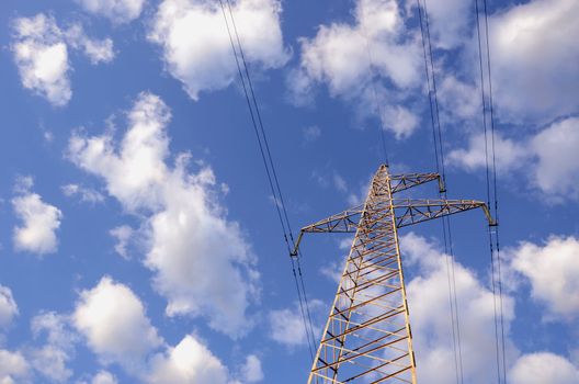 High-voltage electricity wires and poles in the background of clouds.