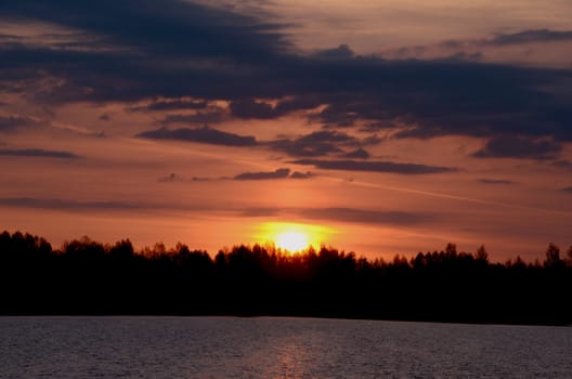 Colorful early spring sunrise over the lake. Unforgettable view.