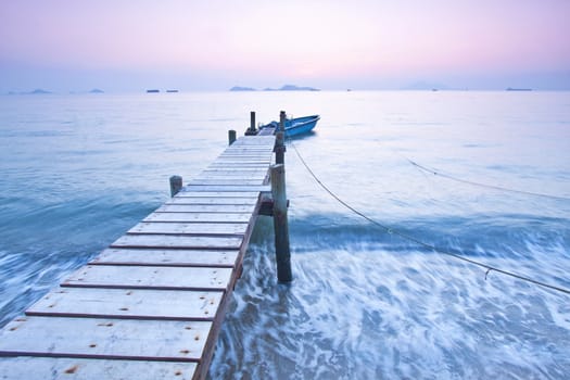 Jetty sunset along coast with waves movement