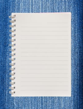 Blank paper with on  blue jeans background