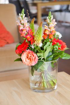 Modern interior with bouguet of flowers in glass vase on table