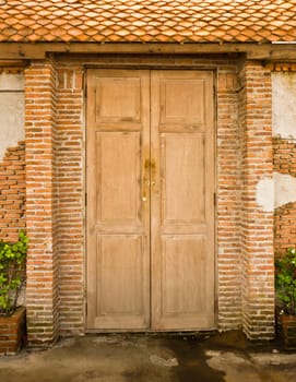 Grunge door background with brick wall