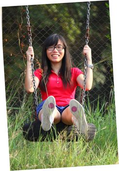 Asian woman playing swing with happy face