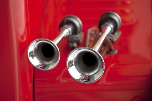 Old fire truck horn with red background