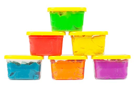 A stack of jars with plasticine of different colors