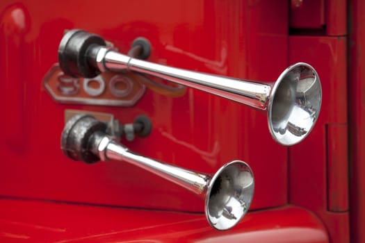 Old fire truck horn with red background