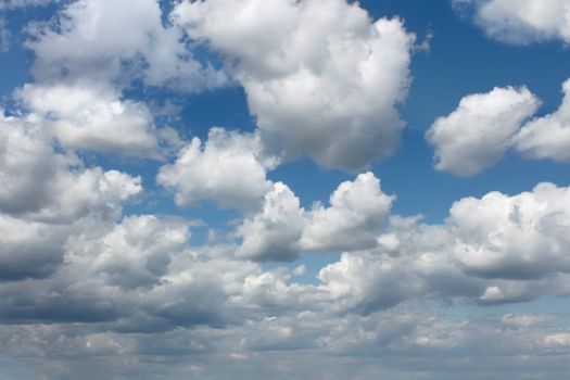 Cloudscape. White clouds floating through a blue sky