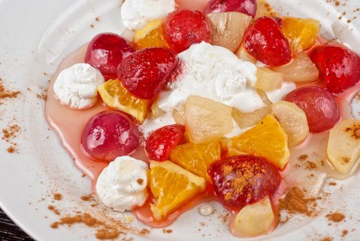 fruit salad of pineapple, grape, orange and strawberry with whipped cream