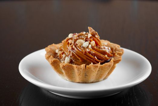 fresh baked cupcake with nuts on a wooden table