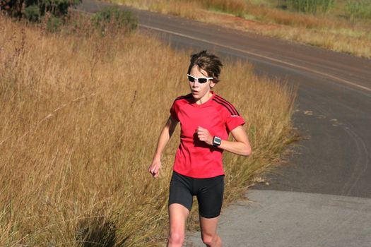 Female athlete in red running.