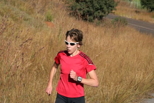 Female athlete in red running.