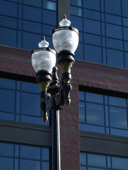 Electric Lamp post outside of a modern styled building.